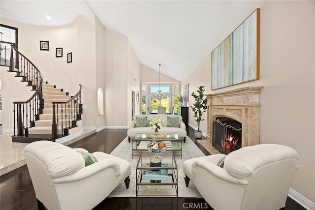 11900 Laughton Way, Porter Ranch, CA 91326 - living room featuring a high end fireplace, high vaulted ceiling, stairway, wood finished floors, and a chandelier