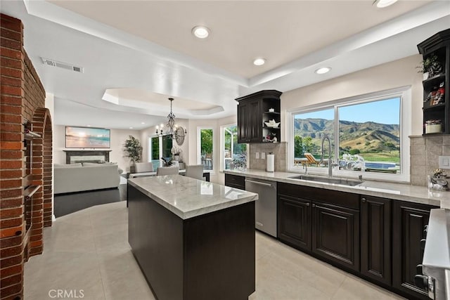 11900 Laughton Way, Porter Ranch, CA 91326 - kitchen with open shelves, a tray ceiling, light tile patterned floors, a center island, and decorative backsplash