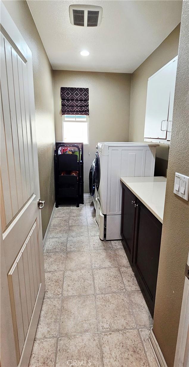 15048 Westin Ln, La Mirada, CA 90638 - laundry room with cabinet space and washing machine and dryer
