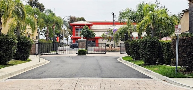 15048 Westin Ln, La Mirada, CA 90638 - view of asphalt road featuring a gate, curbs, and a gated entry