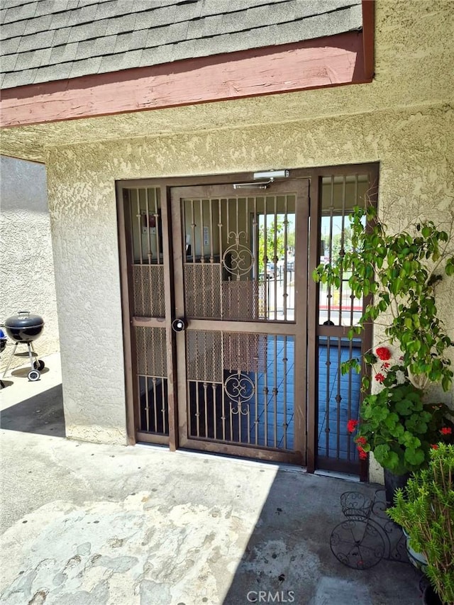 13325 Kornblum Ave, Hawthorne, CA 90250 - doorway to property with stucco siding, a gate, and roof with shingles