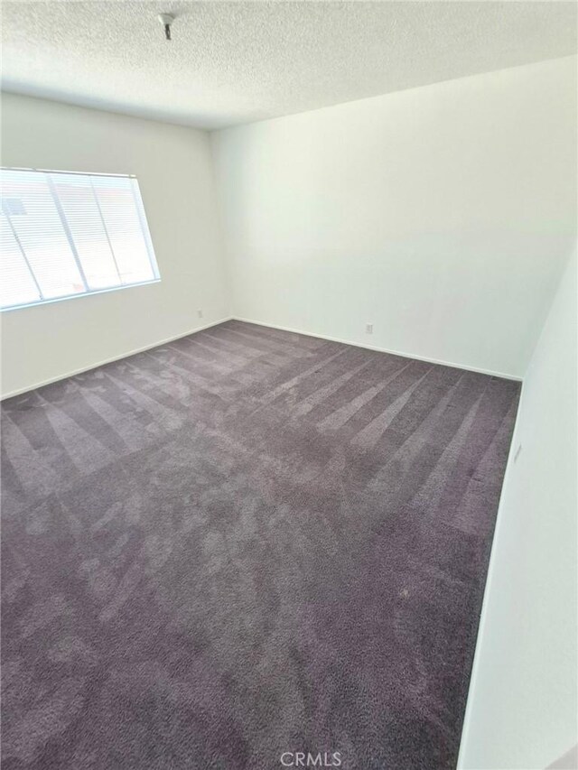 13325 Kornblum Ave, Hawthorne, CA 90250 - carpeted spare room with a textured ceiling