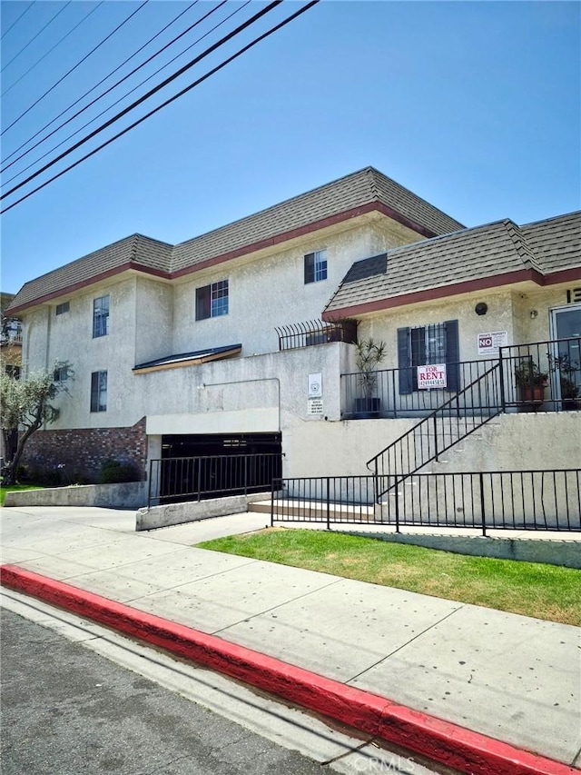 13325 Kornblum Ave, Hawthorne, CA 90250 - view of front of home with stucco siding and a fenced front yard