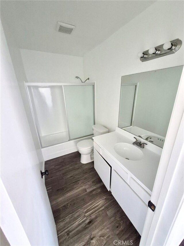 13325 Kornblum Ave, Hawthorne, CA 90250 - bathroom with shower / bath combination with glass door, vanity, and wood finished floors