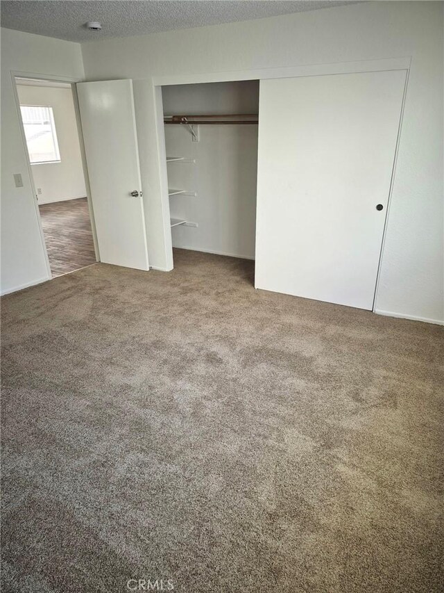 13325 Kornblum Ave, Hawthorne, CA 90250 - unfurnished bedroom with carpet, a closet, and a textured ceiling