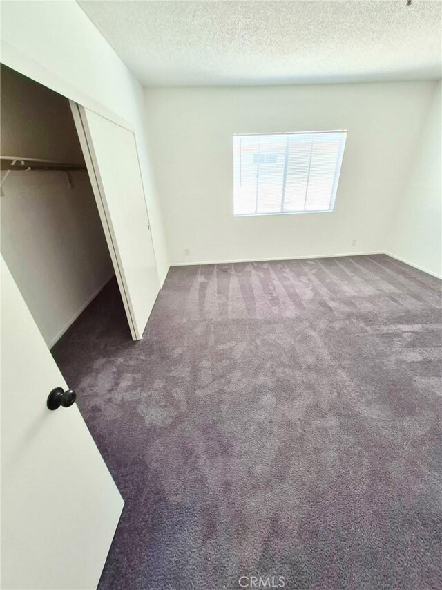 13325 Kornblum Ave, Hawthorne, CA 90250 - unfurnished bedroom with a textured ceiling, carpet flooring, and a closet
