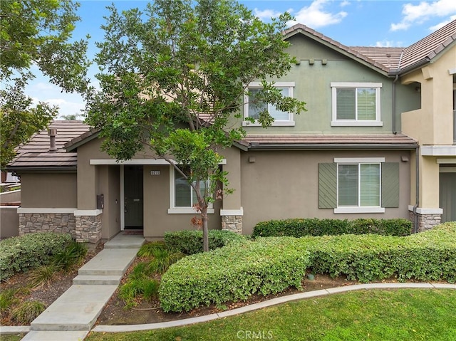8015 Yeager St, Chino, CA 91708 - view of front of home featuring stone siding, stucco siding, and a tiled roof