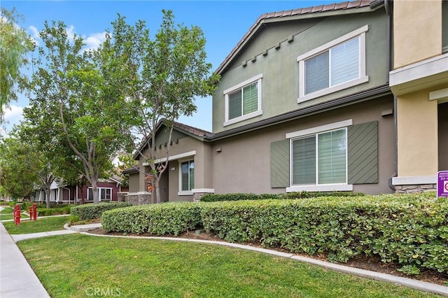 8015 Yeager St, Chino, CA 91708 - view of front of house with stucco siding and a front yard