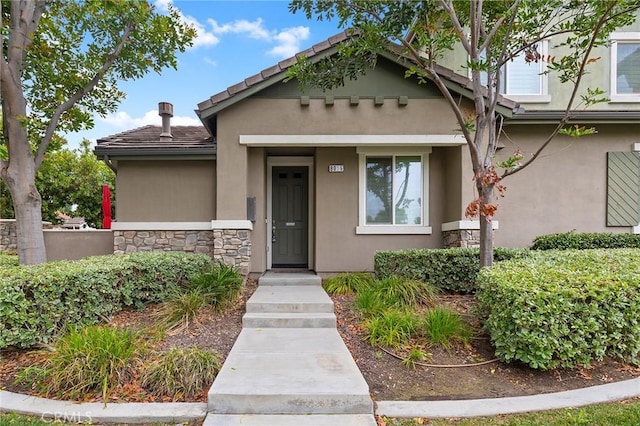 8015 Yeager St, Chino, CA 91708 - view of front of property with stucco siding, stone siding, and a tiled roof