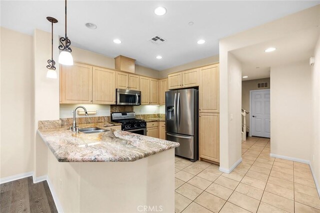 8015 Yeager St, Chino, CA 91708 - kitchen featuring appliances with stainless steel finishes, light brown cabinets, a peninsula, light stone counters, and recessed lighting