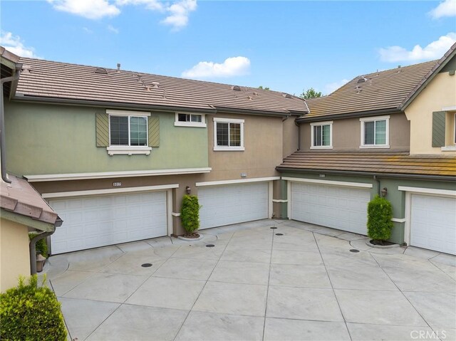 8015 Yeager St, Chino, CA 91708 - multi unit property featuring a tile roof, an attached garage, driveway, and stucco siding