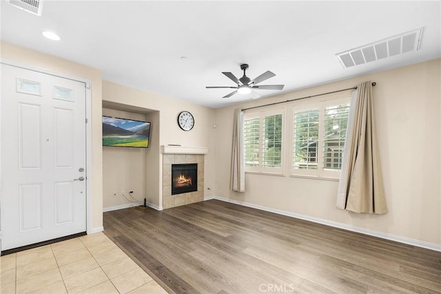 8015 Yeager St, Chino, CA 91708 - unfurnished living room featuring ceiling fan, a tiled fireplace, light wood-style flooring, and recessed lighting