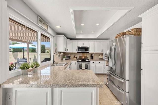 3112 N Hearthside St, Orange, CA 92865 - kitchen with stainless steel appliances, white cabinets, tile countertops, backsplash, and recessed lighting