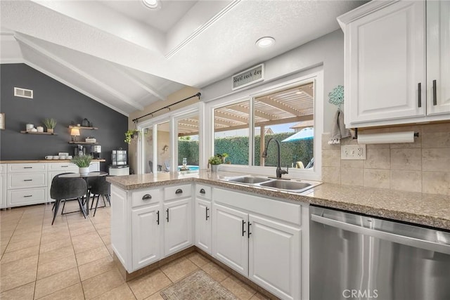 3112 N Hearthside St, Orange, CA 92865 - kitchen featuring dishwasher, white cabinetry, tasteful backsplash, light tile patterned floors, and lofted ceiling
