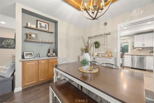 3112 N Hearthside St, Orange, CA 92865 - dining room featuring a chandelier, dark wood-style flooring, bar with sink, and recessed lighting