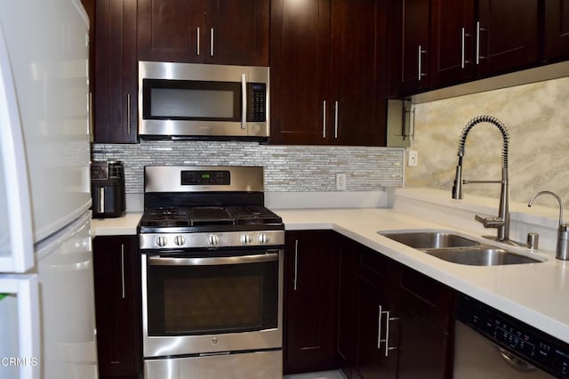 10149 Commerce Ave Unit 2, Tujunga, CA 91042 - kitchen featuring appliances with stainless steel finishes, light countertops, tasteful backsplash, and dark brown cabinets