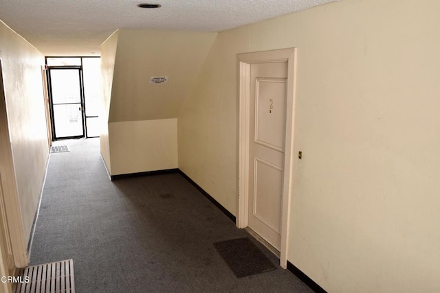 10149 Commerce Ave Unit 2, Tujunga, CA 91042 - hallway featuring a textured ceiling and dark carpet