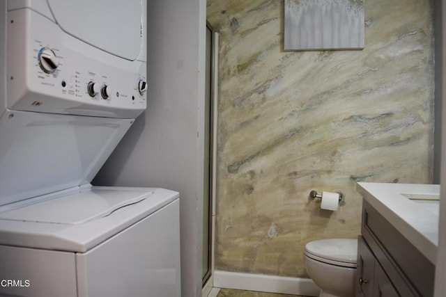 10149 Commerce Ave Unit 2, Tujunga, CA 91042 - laundry room with stacked washing machine and dryer and baseboards