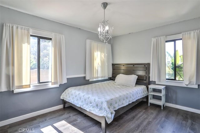 1853 E Renshaw St, Covina, CA 91724 - bedroom featuring a chandelier, multiple windows, and dark wood finished floors