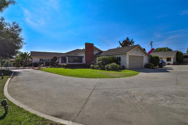 1853 E Renshaw St, Covina, CA 91724 - single story home featuring concrete driveway, a garage, a front yard, and a chimney