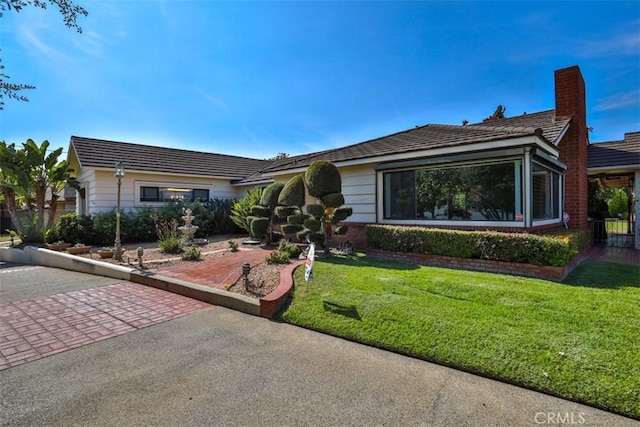 1853 E Renshaw St, Covina, CA 91724 - single story home with a front yard and a chimney