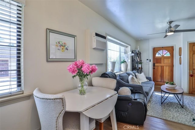 1853 E Renshaw St, Covina, CA 91724 - living room with wood finished floors, ceiling fan, and a wall mounted air conditioner