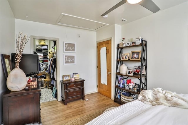 1853 E Renshaw St, Covina, CA 91724 - bedroom with attic access, light wood-style floors, a walk in closet, a closet, and a ceiling fan