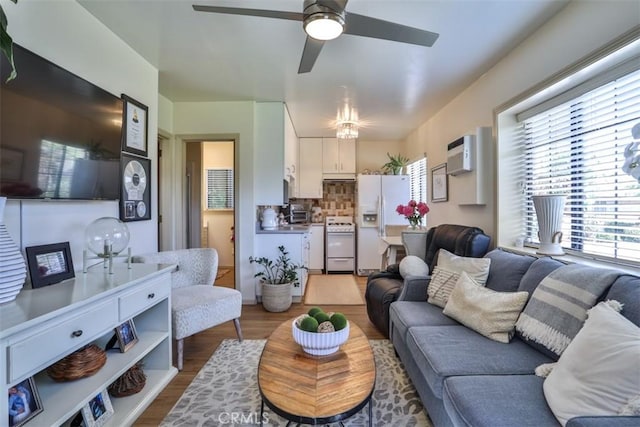 1853 E Renshaw St, Covina, CA 91724 - living area with wood finished floors, a ceiling fan, and a wall unit AC