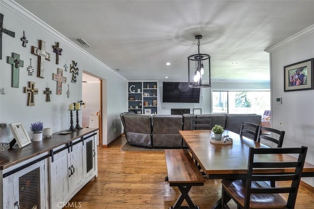 1853 E Renshaw St, Covina, CA 91724 - dining space featuring light wood-style floors, ornamental molding, a fireplace, and recessed lighting