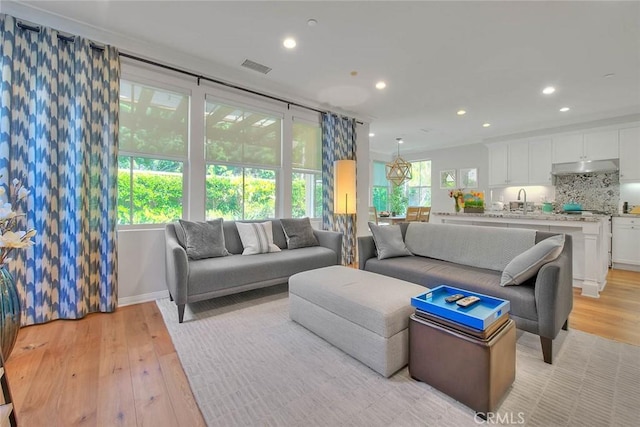 25 Sedgewick, Irvine, CA 92620 - living room featuring light wood-style floors and recessed lighting
