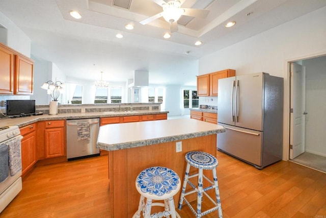 36748 Parrot Mountain Rd, Ranchita, CA 92066 - kitchen with appliances with stainless steel finishes, light wood-style floors, a peninsula, a center island, and a kitchen breakfast bar