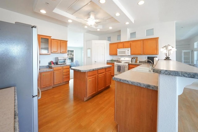 36748 Parrot Mountain Rd, Ranchita, CA 92066 - kitchen with white appliances, a raised ceiling, light wood finished floors, a breakfast bar area, and ceiling fan
