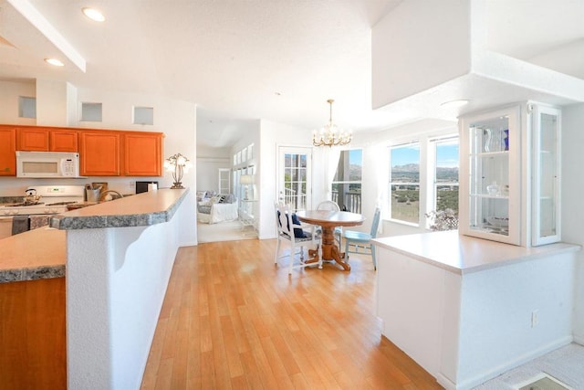 36748 Parrot Mountain Rd, Ranchita, CA 92066 - kitchen with white appliances, brown cabinetry, light wood-type flooring, a chandelier, and recessed lighting