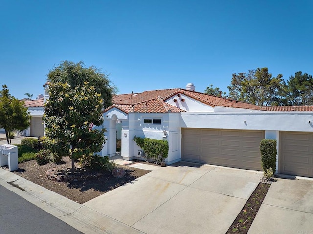 5073 Mycenae Way, Oceanside, CA 92056 - mediterranean / spanish house featuring stucco siding, a tiled roof, concrete driveway, and an attached garage