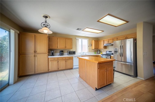 3309 Kaylyn St, Lancaster, CA 93535 - kitchen featuring appliances with stainless steel finishes, under cabinet range hood, a center island, pendant lighting, and light tile patterned floors