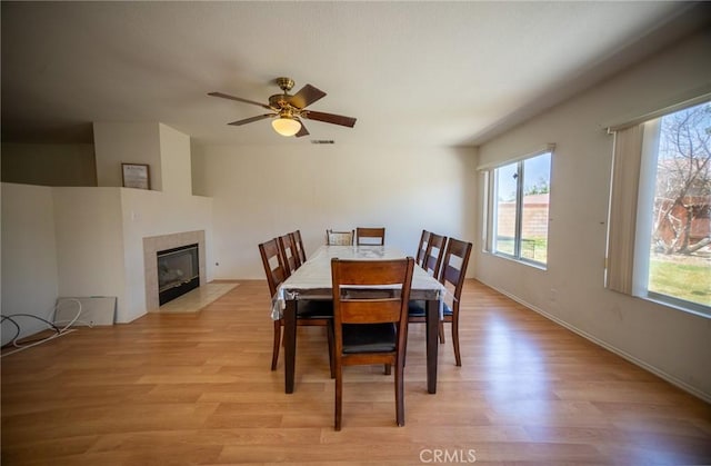 3309 Kaylyn St, Lancaster, CA 93535 - dining space with plenty of natural light, light wood-style floors, a fireplace, and ceiling fan
