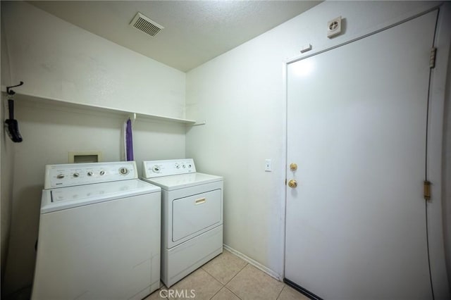 3309 Kaylyn St, Lancaster, CA 93535 - laundry area with washer and dryer and light tile patterned floors