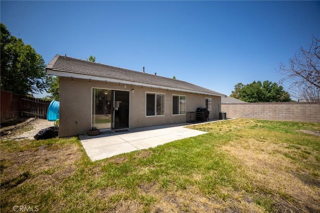 3309 Kaylyn St, Lancaster, CA 93535 - rear view of house featuring a fenced backyard, a patio, and stucco siding