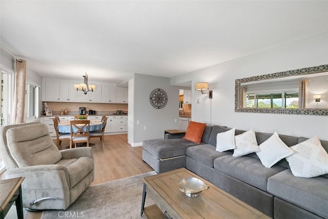 856 Ronda Mendoza Unit P, Laguna Woods, CA 92637 - living room featuring a chandelier and light wood finished floors