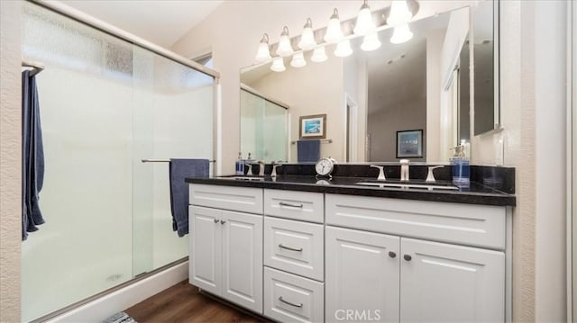 7192 Carano Pl, Rancho Cucamonga, CA 91701 - full bathroom featuring double vanity, a shower stall, and wood finished floors