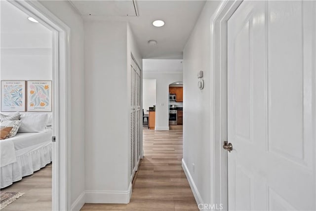 9123 National Blvd Unit 1, Los Angeles, CA 90034 - hallway featuring light wood-type flooring, arched walkways, recessed lighting, and attic access