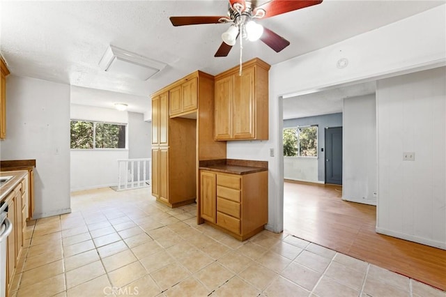 25286 N Rd, Twin Peaks, CA 92391 - kitchen featuring plenty of natural light, dark countertops, light tile patterned floors, and ceiling fan