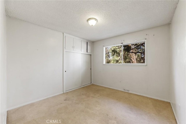 25286 N Rd, Twin Peaks, CA 92391 - unfurnished bedroom featuring light carpet, a closet, and a textured ceiling