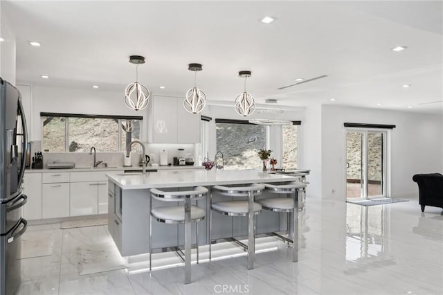 11911 Louise Ave, Granada Hills, CA 91344 - kitchen with freestanding refrigerator, modern cabinets, light countertops, white cabinets, and recessed lighting