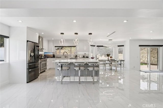 11911 Louise Ave, Granada Hills, CA 91344 - kitchen with refrigerator with ice dispenser, high end stainless steel range, white cabinetry, a kitchen island, and recessed lighting