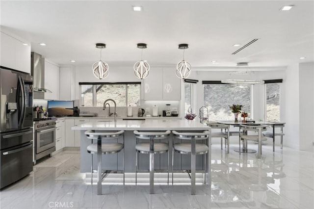 11911 Louise Ave, Granada Hills, CA 91344 - kitchen featuring black fridge, high end range, wall chimney exhaust hood, white cabinets, and recessed lighting