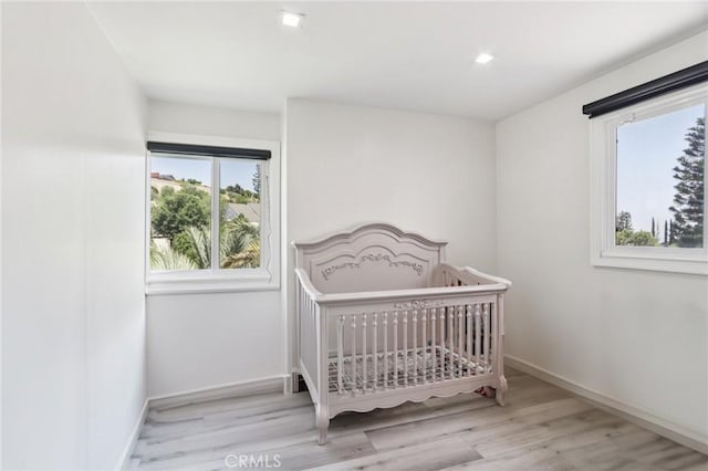 11911 Louise Ave, Granada Hills, CA 91344 - bedroom with wood finished floors and a nursery area