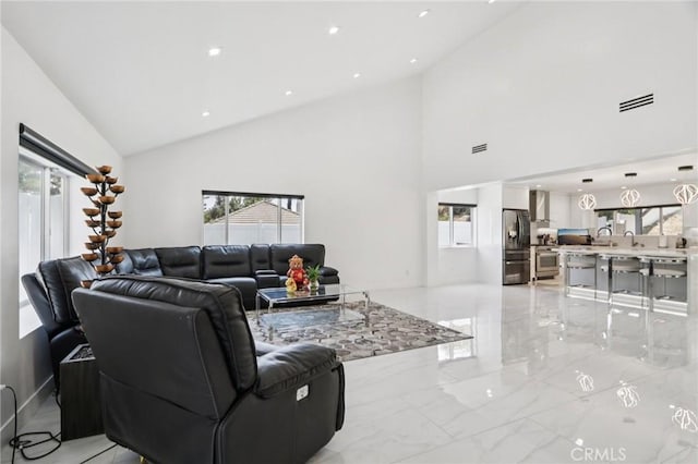11911 Louise Ave, Granada Hills, CA 91344 - living room with light marble finish floors, high vaulted ceiling, and recessed lighting