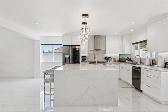 11911 Louise Ave, Granada Hills, CA 91344 - kitchen featuring modern cabinets, appliances with stainless steel finishes, wall chimney exhaust hood, tasteful backsplash, and light marble finish floors