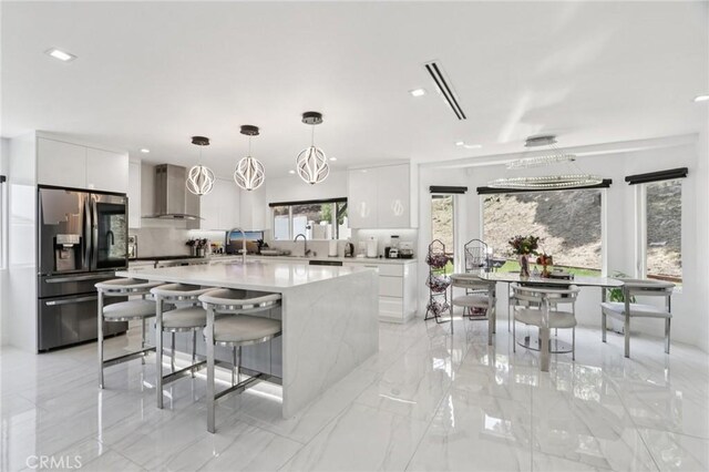 11911 Louise Ave, Granada Hills, CA 91344 - kitchen with stainless steel refrigerator with ice dispenser, wall chimney exhaust hood, modern cabinets, white cabinets, and recessed lighting